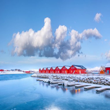 Breathtaking scenery wit traditional red wooden houses on the shore of Offersoystraumen fjord. Popular travel destination on Lofotens. Location: Vestvagoy island, Lofoten; Norway, Europe
