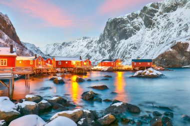 Fantastic evening  seascape of Norwegian sea and cityscape of Nusfjord village. Popular travel destination on Lofotens. Location: Nusfjord, Flakstad Municipality, Lofoten; Norway, Europe