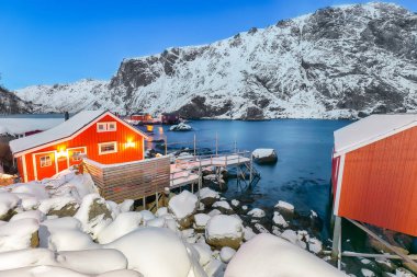 Fantastic evening  seascape of Norwegian sea and cityscape of Nusfjord village. Popular travel destination on Lofotens. Location: Nusfjord, Flakstad Municipality, Lofoten; Norway, Europe