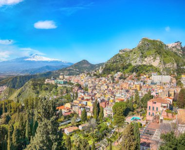 Awesome view of Taormina resorts and Etna volcano mount. Giardini-Naxos bay, Ionian sea coast, Taormina, Sicily, Italy.