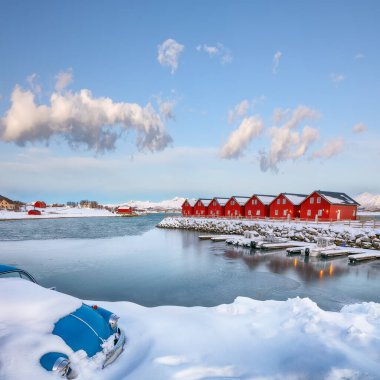 Breathtaking scenery wit traditional red wooden houses on the shore of Offersoystraumen fjord. Popular travel destination on Lofotens. Location: Vestvagoy island, Lofoten; Norway, Europe
