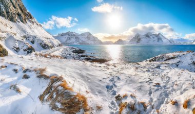 Picturesque winter view on Flakstad coastline seen from the oposite side in the morning. Popular tourist destination. Location: Flakstadoya island, Lofoten; Norway, Europe