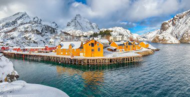 Awesome morning seascape of Norwegian sea and cityscape of Nusfjord village. Popular travel destination on Lofotens. Location: Nusfjord, Flakstad Municipality, Lofoten; Norway, Europe
