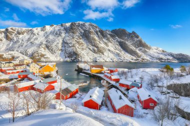 Awesome morning seascape of Norwegian sea and cityscape of Nusfjord village. Popular travel destination on Lofotens. Location: Nusfjord, Flakstad Municipality, Lofoten; Norway, Europe