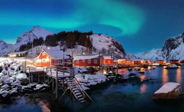 Fabulous evening  seascape of Norwegian sea and cityscape of Nusfjord village with Northern Lights. Location: Nusfjord, Flakstad Municipality, Lofoten; Norway, Europe