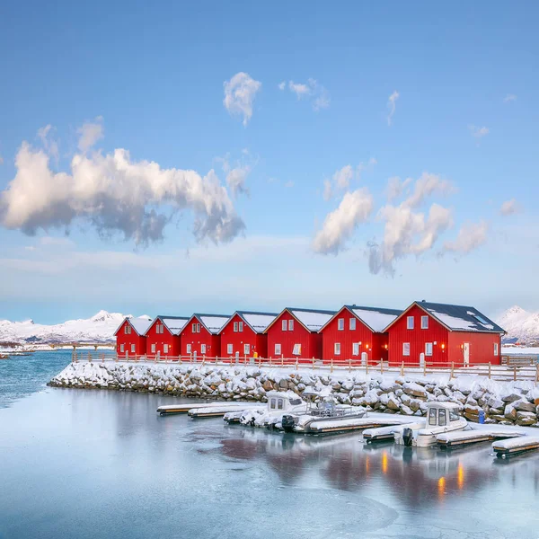 Gorgeous scenery wit traditional red wooden houses on the shore of Offersoystraumen fjord. Popular travel destination on Lofotens. Location: Vestvagoy island, Lofoten; Norway, Europe