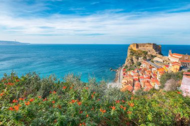 Awesome seaside and village Scilla with old medieval castle on rock Castello Ruffo, colorful traditional typical italian houses on Mediterranean Tyrrhenian sea coast shore, Calabria, Southern Italy