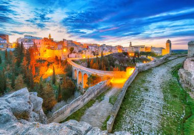 Fabulous view on Gravina in Puglia ancient town, bridge and canyon at sunrise. Panoramic view of old city Gravina in Puglia, Apulia, Italy. Europe