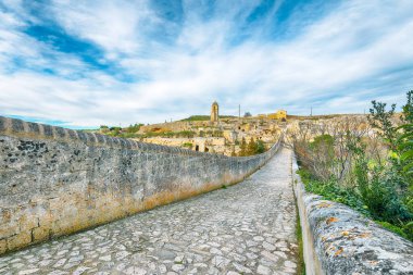 Breathtaking view on Gravina in Puglia ancient town, bridge and canyon at sunrise. Panoramic view of old city Gravina in Puglia, Apulia, Italy. Europe