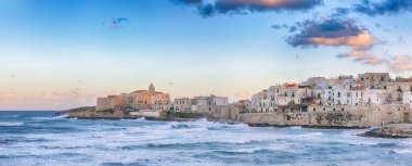 Breathtaking view of historic center and promenade of the city of Vieste at sunset. View at the coast of Vieste on Puglia, Italy, Europe