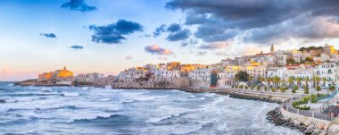 Marvelous view of historic center and promenade of the city of Vieste at sunset. View at the coast of Vieste on Puglia, Italy, Europe