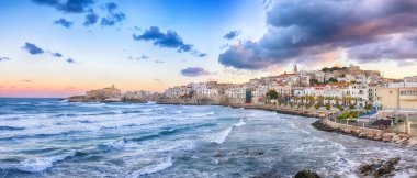 Breathtaking view of historic center and promenade of the city of Vieste at sunset. View at the coast of Vieste on Puglia, Italy, Europe