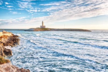 Stunning view on Lighthouse of Vieste, rising on the isle of Santa Eufemia. Lighthouse In Vieste, Gargano Peninsula, Apulia region, Italy, Europe