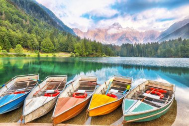 Arka planda Mangart zirvesi olan Fusine Gölü 'nün üzerindeki gün batımının inanılmaz manzarası. Julian Alps 'in popüler seyahat yeri. Konum: Tarvisio komünü, Udine ili, İtalya, Avrupa