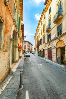Verona 'nın tarihi ortaçağ şehir merkezindeki dükkanlar ve kafelerden oluşan fantastik dar bir cadde. Konum: Verona, Veneto bölgesi, İtalya, Avrupa