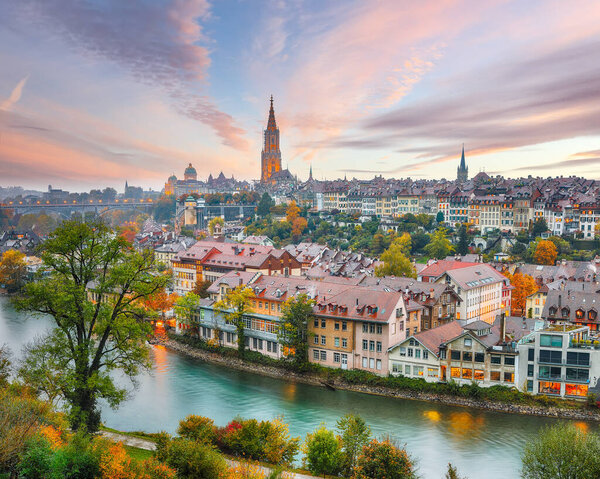 Fabulous autumn view of Bern city on Aare river during evening with Cathedral of Bern on background. Location: Bern, Canton of Bern, Switzerland, Europe