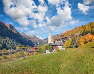 Amazing autumn landscape  at Heiligenblut with St Vincent Church near Grossglockner mount . Popular travel destination.  Location:  Heiligenblut , Carinthia state,  Spittal an der Drau district,  Austria clipart