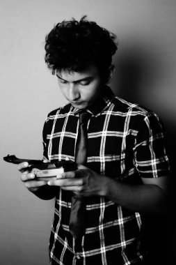 young boy looking down and wearing with camera b&w image