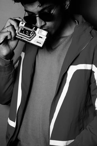 young boy wearing jacket and black glass with camera, black and white image