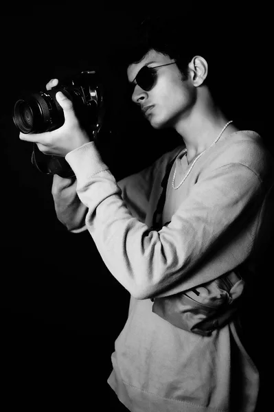 smart young boy wearing t shirt with camera, black and white image black glass