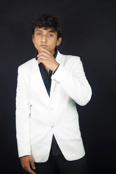 Handsome man wearing blazer against black background