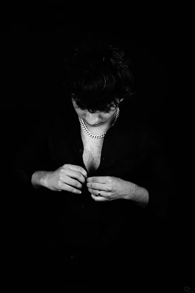 Tough man wearing black shirt over black background