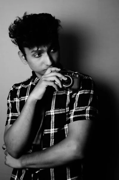 young boy looking side and wearing with camera black and white