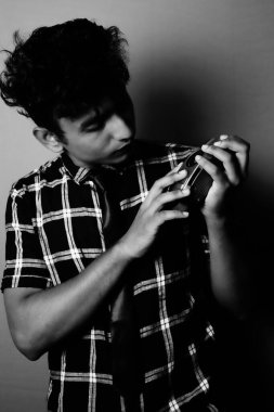 young boy looking to camera and wearing with camera black and white