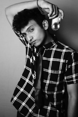 young boy looking front and wearing with camera black and white