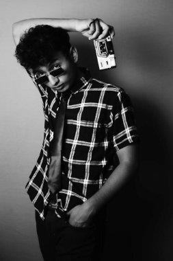 young boy wearing sun glass and shirt with camera and looking front, black and white image