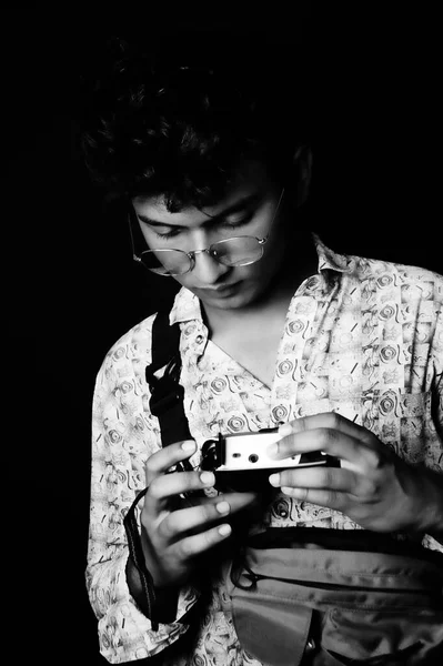 smart young boy , wearing glass with bag ,black and white image