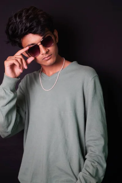 smart young boy , wearing glass and t shirt image , side look