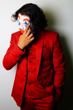 male joker face in sad pose image