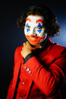 joker face male with happy fake smile in red formal image