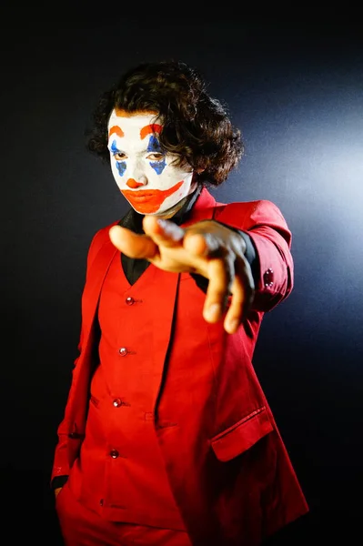 boy in joker face , posing with hand image