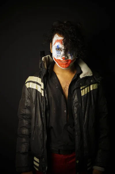 man with joker face , front look pose and smiling in jacket image