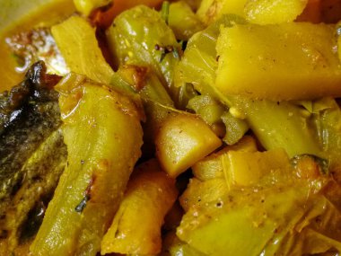 Lezzetli balık körisi. Balık parçaları, karışık baharatlar, şişe kabağı, domates, patates, zeytinyağı, kişniş yapraklarından yapılan geleneksel yemek.