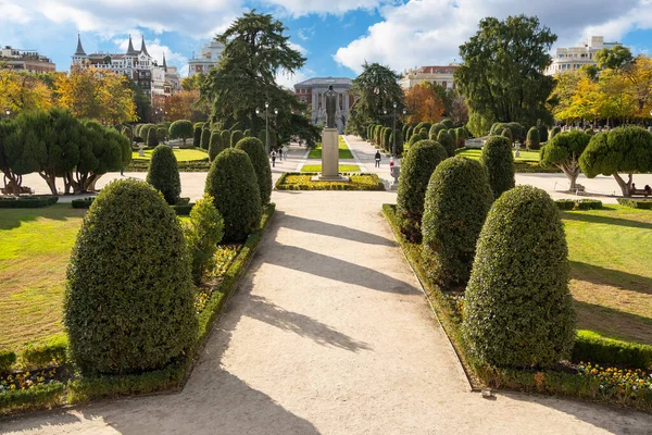 Botanical garden with trimmed hedges and dirt paths in Madrids Retiro Park