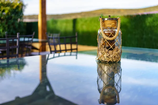Glass jar with stones on top of a rustic country house table