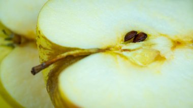 Apple heart cut in half with its seeds visible inside, macrophotograph
