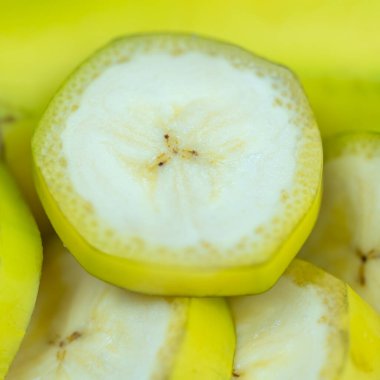 Background of banana slices cut into thin pieces and stacked, macrophotography