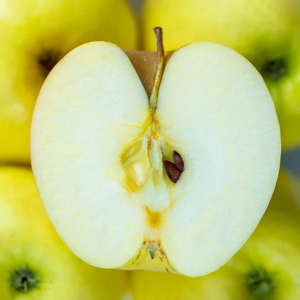 Apple heart cut in half with its seeds visible inside, macrophotograph