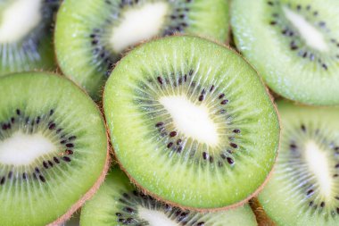 Stacked slices of kiwi fruit in a macro, background and texture photo shot