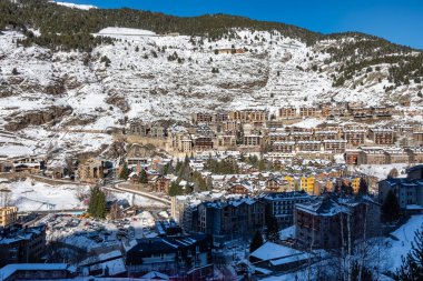 Urbanization of mountain houses on the slope of the snowy mountain in the Pyrenees, Andorra