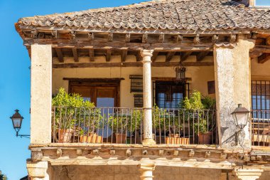 Typical balcony of the medieval town of stonework in stone building with wooden roof and tile, Pedraza, Spain