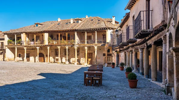 Main square of the city of Pedraza with its medieval buildings supported with wooden columns and balconies, Segovia, Spain