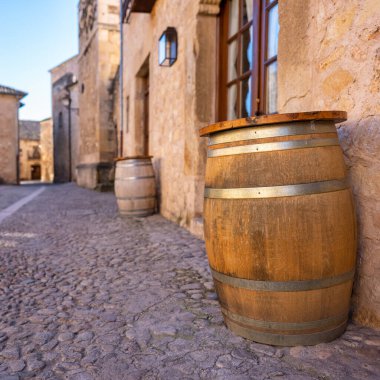Wooden barrel to store wine in the narrow streets of the medieval village of Pedraza, Segovia
