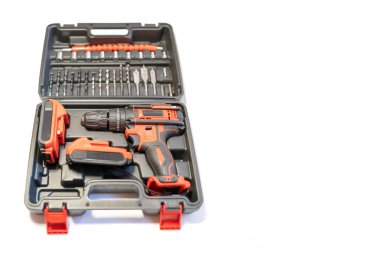 Tool case with electric drill of batteries without cables and different bits and screwdrivers, photo copyspace