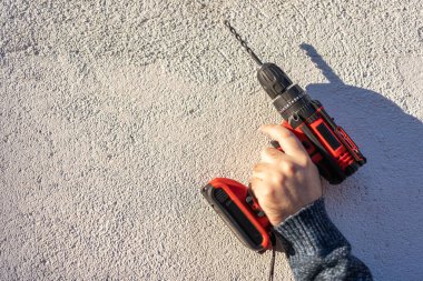 Electric drill and screwdriver of batteries without cables, isolated on white background, photo copyspace