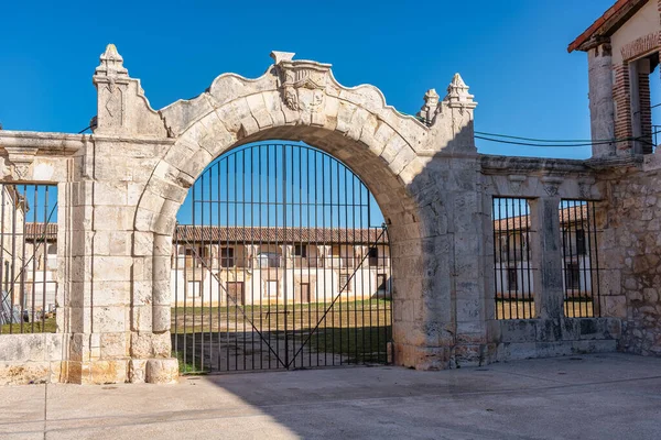 Architectural stone arch that gives entrance to the courtyard of buildings in the monumental area of Nuevo Baztan, Madrid